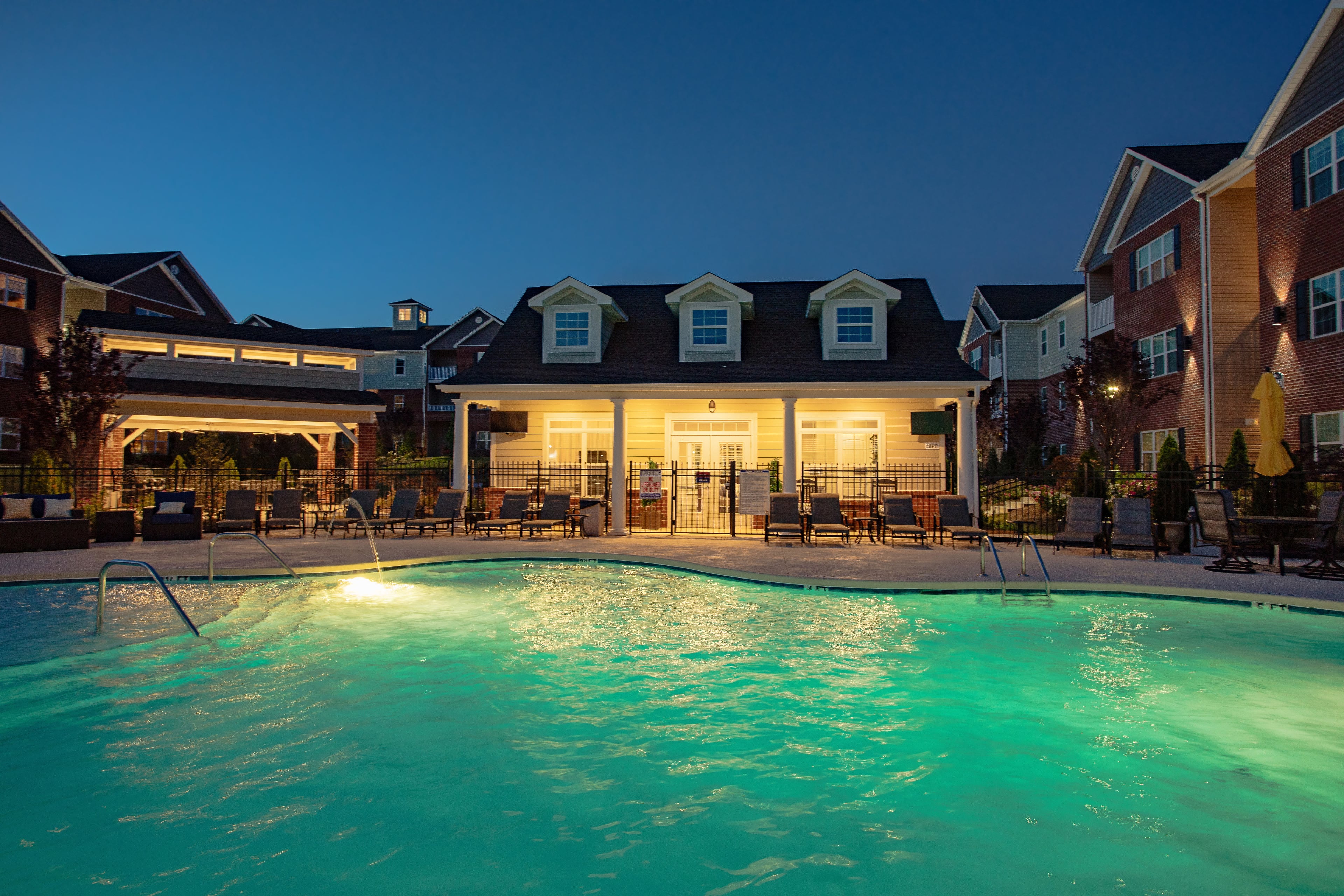 The pool and clubhouse at The Reserve at Brookberry Farm at dusk